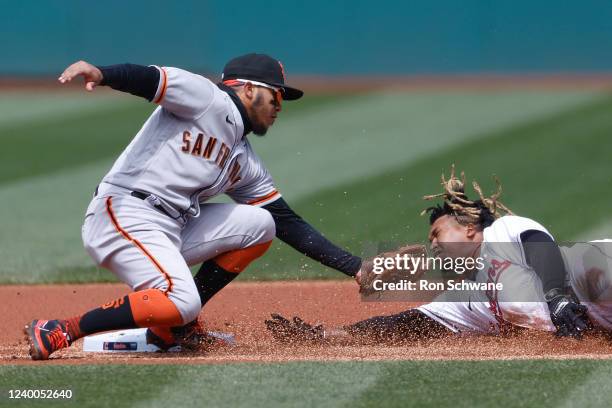 Thairo Estrada of the San Francisco Giants tags out Jose Ramirez of the Cleveland Guardians at second base during the first inning at Progressive...