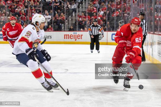 Danny DeKeyser of the Detroit Red Wings dumps the puck past Ben Chiarot of the Florida Panthers during the first period of an NHL game at Little...