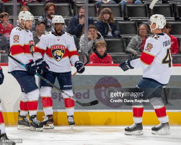 Aleksander Barkov and Gustav Forsling of the Florida Panthers congratulate teammate Anthony Duclair after he scores a goal during the second period...
