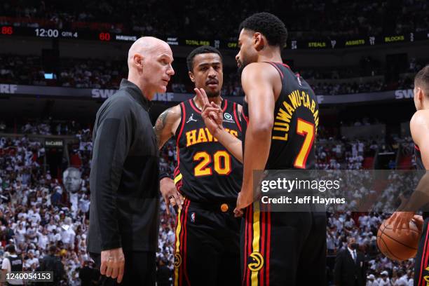 Assistant Coach Chris Jent talks to John Collins and Timothe Luwawu-Cabarrot of the Atlanta Hawks during the game against the Miami Heat during Round...