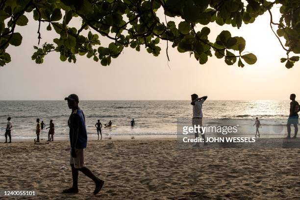People are seen along Lumley beach in Freetown on April 17, 2022.
