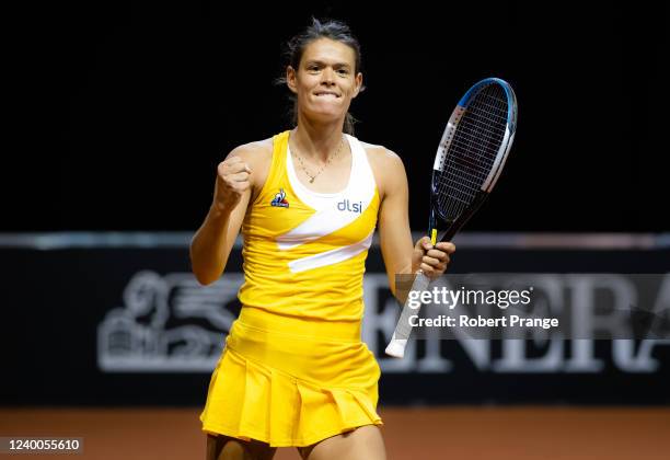 Chloe Paquet of France in action against Stefanie Voegele of Switzerland in the second qualifications round of the Porsche Tennis Grand Prix...