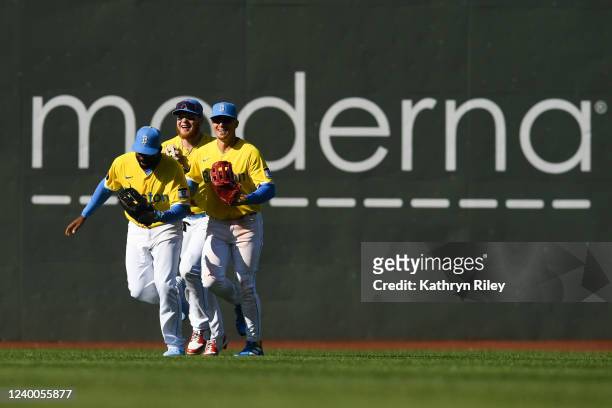 Jackie Bradley Jr. #19, Alex Verdugo, and Kiké Hernandez of the Boston Red Sox celebrate together after a win against the Minnesota Twins at Fenway...