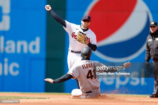 Owen Miller of the Cleveland Guardians forces out Wilmer Flores of the San Francisco Giants at second base during the fourth inning at Progressive...