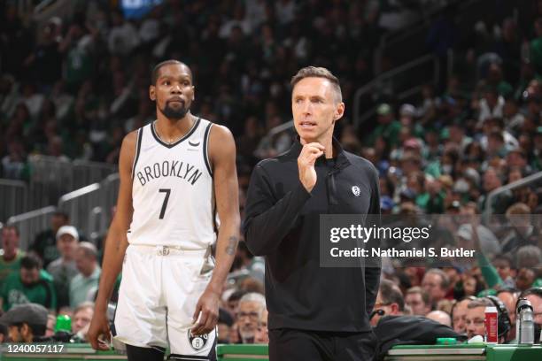 Kevin Durant of the Brooklyn Nets and Head Coach Steve Nash look on against the Boston Celtics during Round 1 Game 1 of the 2022 NBA Playoffs on...