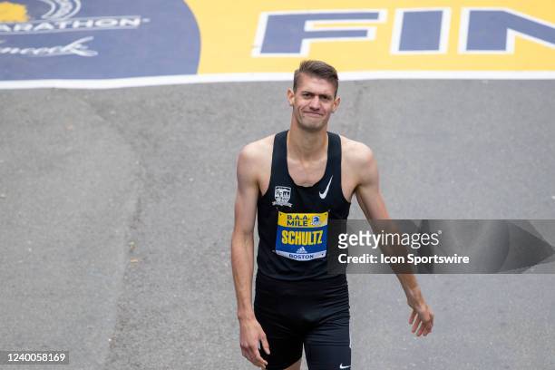 Colin Schultz of the United States reacts to crossing the finish line of the B.A.A. Invitational Mile men's professional race on April 16, 2022 on...
