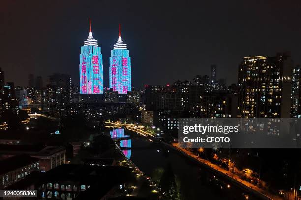 Night-view light show of the twin towers of the landmark Global Harbor Shopping Mall flashes the words "Go Shanghai, Love together" to cheer Shanghai...