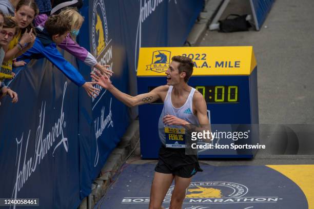 Mason Ferlic, of the United States, who competed in the men's 3000 meters steeplechase event at the 2020 Summer Olympics in Tokyo, Japan, high-fives...
