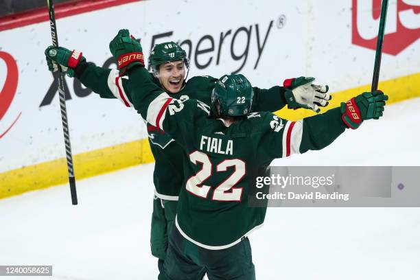 Jared Spurgeon celebrates his game winning goal with Kevin Fiala of the Minnesota Wild against the San Jose Sharks to clinch a berth to the Stanley...