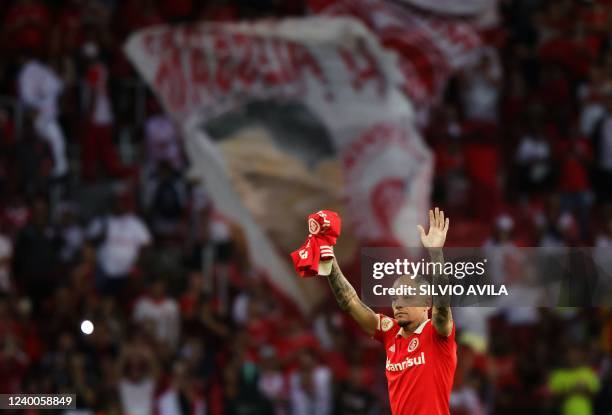 Brazil's Internacional Argentine attacking midfielder Andres D'Alessandro waves at the crowd at the end of his last match as professional footballer,...