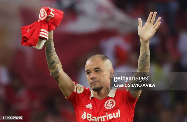 Brazil's Internacional Argentine attacking midfielder Andres D'Alessandro waves at the crowd at the end of his last match as professional footballer,...