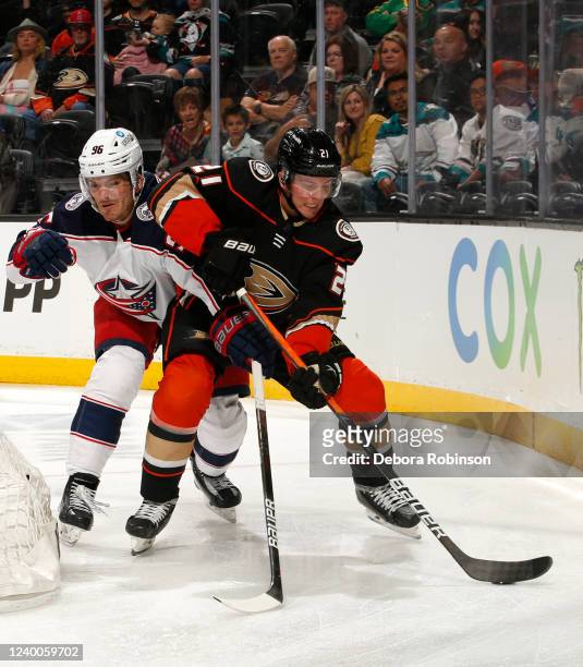 Jack Roslovic of the Columbus Blue Jackets and Isac Lundestrom of the Anaheim Ducks battle for position during the third period at Honda Center on...