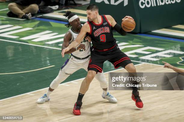 Milwaukee Bucks guard Jrue Holiday guards Chicago Bulls center Nikola Vucevic during the first half of Game One in the NBA Eastern Conference first...