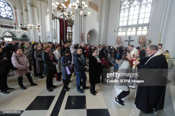 Ukrainian believers receive holy communion as they celebrate Palm Sunday amid Russian invasion. Palm Sunday is the first day of Holy Week and the...