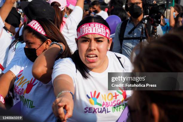 Women x justice" can be read on a headband when feminists and hundreds of people, mostly women, march through the Lima downtown demanding Capital...