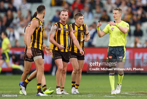Tom Mitchell of the Hawks speaks with AFL Field Umpire, Hayden Gavine after a 50 metre peanut was awarded to Geelong during the 2022 AFL Round 05...