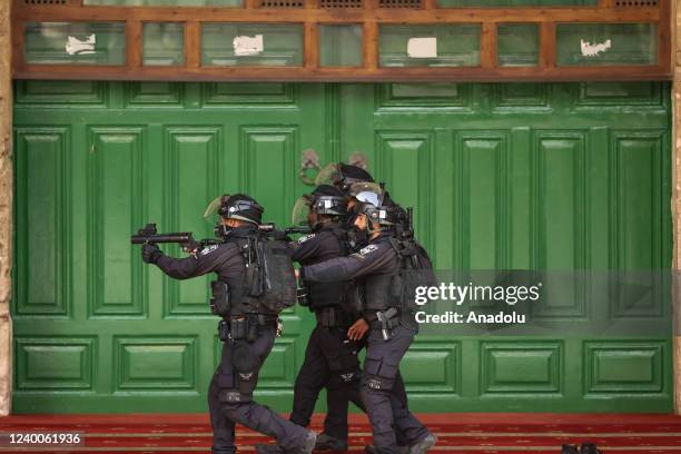 Israeli forces raid Al-Aqsa Mosque after a morning prayer to drive out Palestinian worshippers, in Jerusalem on April 18, 2022. Israeli forces also...