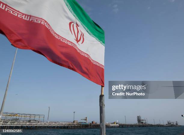 An Iran's flag waves on the wind as a view of the Kharg oil T pier on the Persian Gulf about 1,250 km south of Tehran on February 23, 2016.