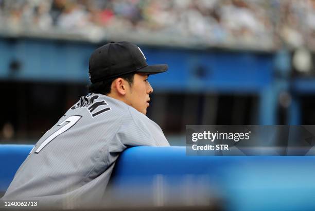 This picture taken on April 17, 2022 shows Lotte Marines pitcher Roki Sasaki watching the Nippon Professional Baseball match between the Chiba Lotte...