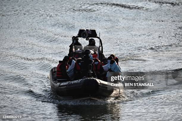 Migrants picked up at sea while attempting to cross the English Channel, are pictured on a UK Border Force boat entering the Marina in Dover, on...