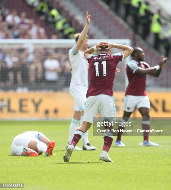 Burnley's Ashley Westwood suffers a bad injury and West Ham United's Nikola Vlasic is shocked during the Premier League match between West Ham United...