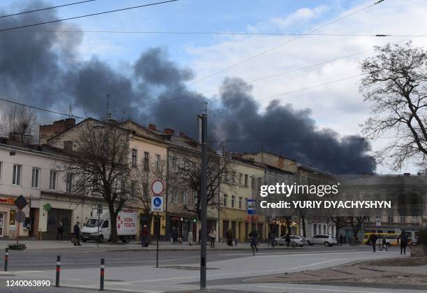 Dark smoke rises following an air strike in the western Ukrainian city of Lviv, on April 18, 2022. - A series of "powerful" Russian strikes on...