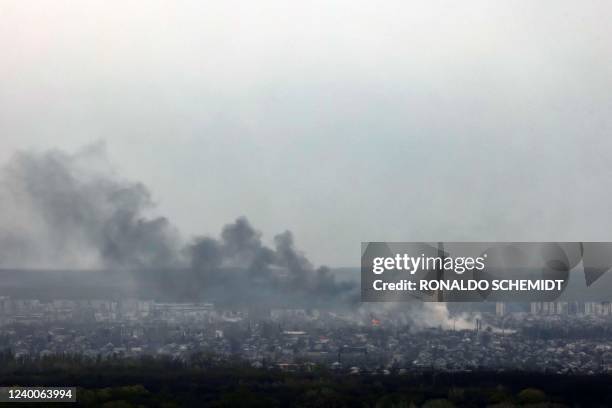 Photograph taken from Novodruzhesk village, shows smoke rising in Rubizhne city, on April 18 on the 54th day of the Russian invasion of Ukraine. - A...