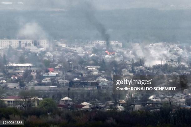 Photograph taken from Novodruzhesk village, shows smoke rising in Rubizhne city, on April 18 on the 54th day of the Russian invasion of Ukraine. - A...