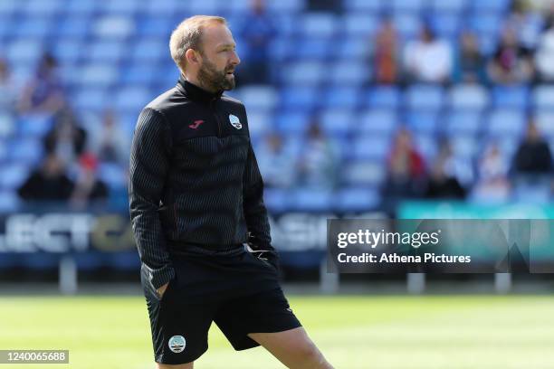 Matt Gill, technical development coach for Swansea City observes his players' warm-up session prior to the Sky Bet Championship match between Reading...