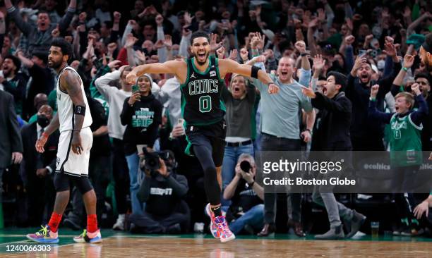 The Celtics Jayson Tatum as well as the fans erupt after his basket at the buzzer defeated Kyrie Irving and the Nets 115-114. The Boston Celtics...