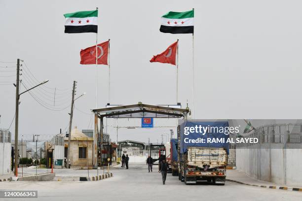 Syrians coming from Turkey go through the Bab al-Salame crossing in the border town of Azaz in the rebel-held north of the Aleppo province, on April...