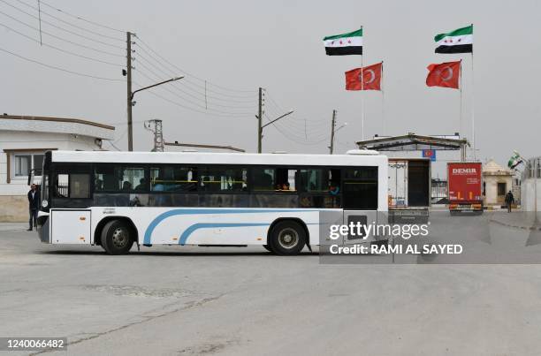 Syrians coming from Turkey go through the Bab al-Salame crossing in the border town of Azaz in the rebel-held north of the Aleppo province, on April...