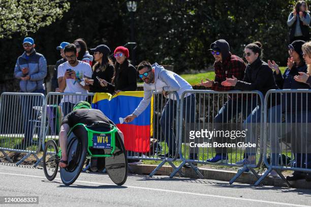 Newton, MA Spectators watch and cheer as contestants peddle up Heartbreak Hill during the 126th Boston Marathon in Newton on April 18, 2022.
