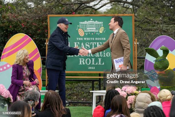 President Joe Biden shakes hands with "Tonight Show" host Jimmy Fallon as he arrives to read to children during the Easter Egg Roll on the South Lawn...