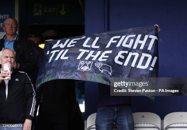 Derby County fan in the stands with a banner reading We'll Fight To The End following their relegation after the Sky Bet Championship match at the...