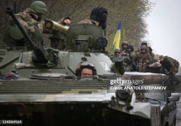 Ukrainian soldiers stand on their armoured personnel carrier , not far from the front-line with Russian troops, in Izyum district, Kharkiv region on...