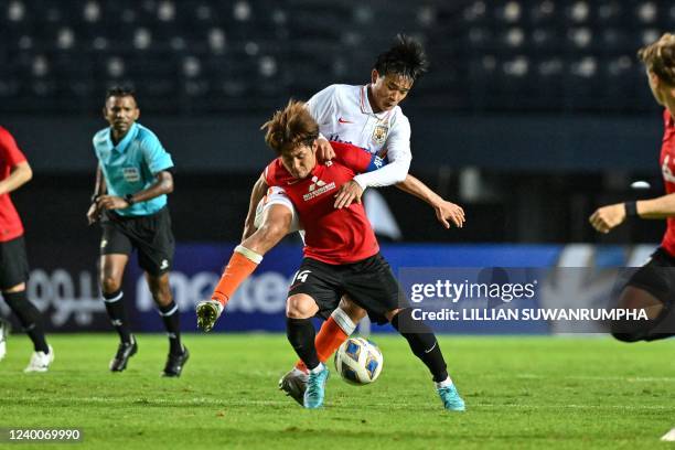 Japans Urawa Reds Takahiro Sekine fights for the ball against Chinas Shandong Taishan Chen Zhexuan during the AFC Champions League Group F football...