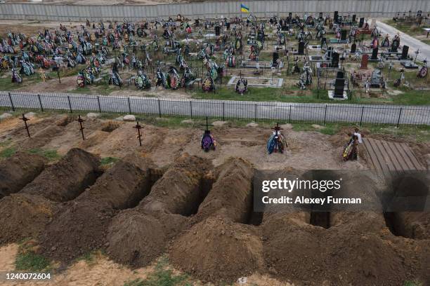 Freshly dug graves are seen at the cemetery on April 18, 2022 in Bucha, Ukraine.