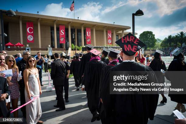 Northridge, CA CSUN grads march onto the Oviatt Library lawn for graduation ceremonies at Cal State Northridge Monday, May 19, 2014.