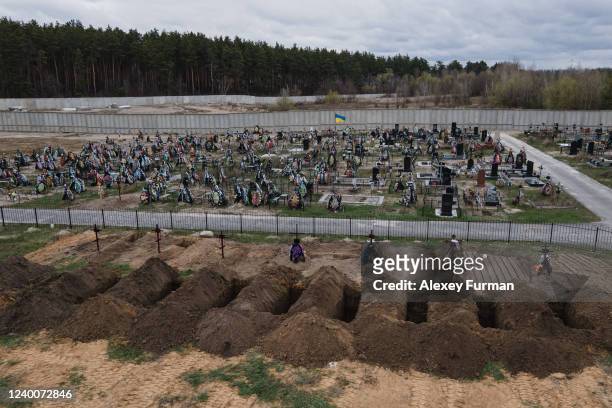 Freshly dug graves are seen at the cemetery on April 18, 2022 in Bucha, Ukraine.