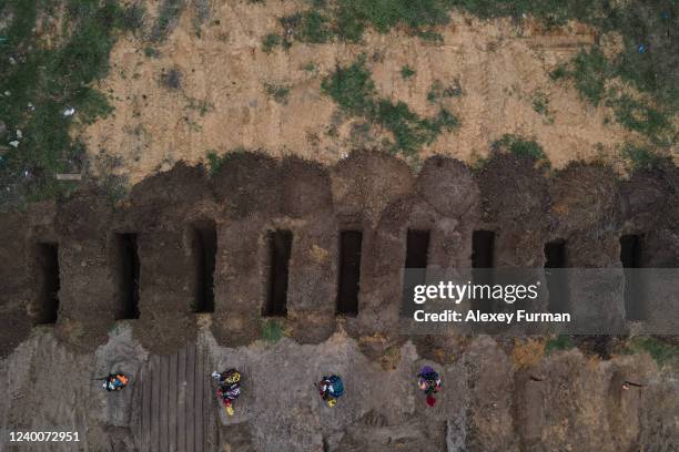 Freshly dug graves are seen at the cemetery on April 18, 2022 in Bucha, Ukraine.