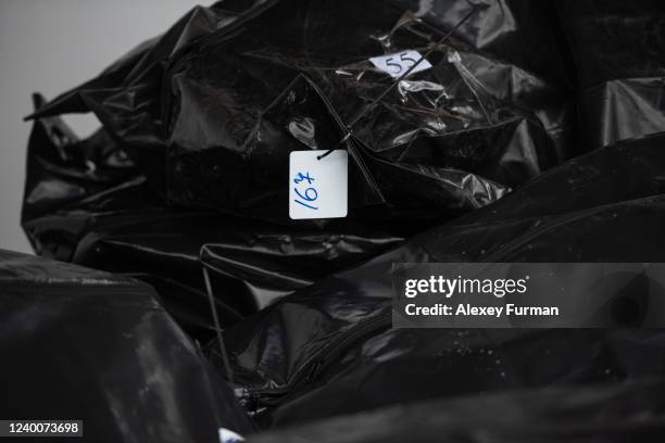 Body bags are seen by the morgue building on April 18, 2022 in Bucha, Ukraine. The Kyiv suburb was heavily damaged in fighting between invading...