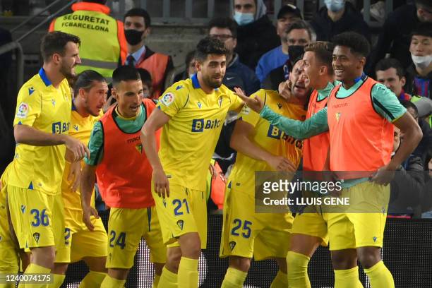 Cadiz's Spanish forward Lucas Perez celebrates with teammates after scoring a goal during the Spanish League football match between FC Barcelona and...
