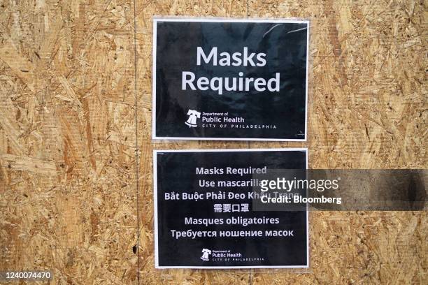 Masks Required' sign outside of a restaurant as the indoor mask mandate is reinstated in Philadelphia, Pennsylvania, U.S, on Monday, April 18, 2022....