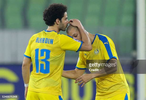Gharafa's forward Ahmed Alaaeldin celebrates his opening goal with Gharafa's midfielder Sofiane Hanni during the AFC Champions League group C match...