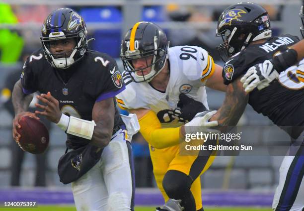 Baltimore Ravens quarterback Tyler Huntley sprints for a first down to the 44-yard line, beyond Pittsburgh Steelers linebacker T.J. Watt , who gets...