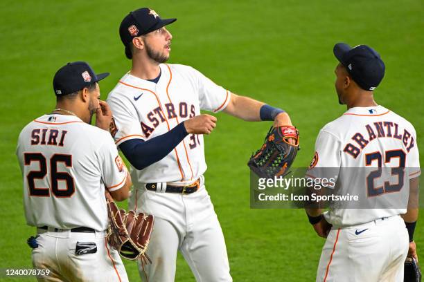 Houston Astros center fielder Jose Siri , Houston Astros right fielder Kyle Tucker , and Houston Astros designated hitter Michael Brantley chat...