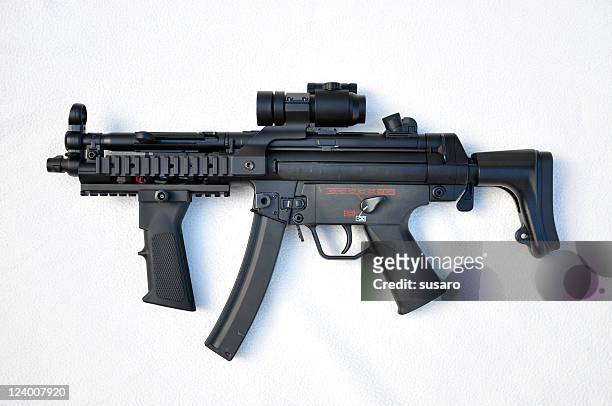 a black machine gun on a white background - maskingevär bildbanksfoton och bilder