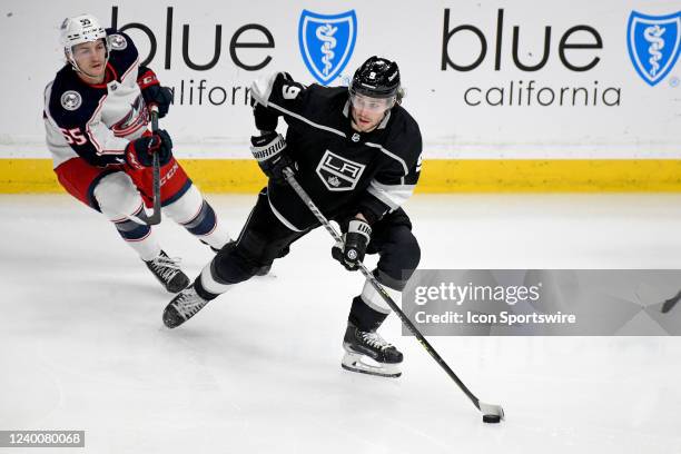 Los Angeles Kings Right Wing Adrian Kempe carries the puck as Columbus Blue Jackets Right Wing Carson Meyer looks on during a Los Angeles Kings game...