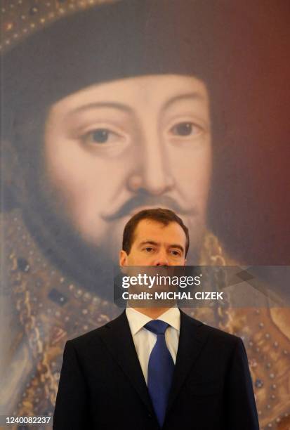 Russian President Dmitry Medvedev stands in front of a giant picture of Tsar Michael of Russia during the opening ceremony of the "Tsar's court under...